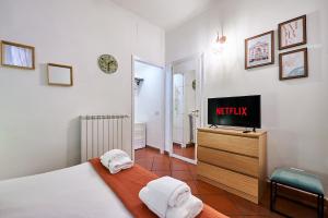 a bedroom with a bed and a tv on a dresser at Rome Bloom - Navona in Rome
