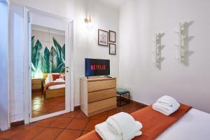 a bedroom with two beds and a television in it at Rome Bloom - Navona in Rome