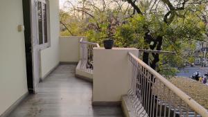 a balcony with stairs and a pot on the wall at Neer Villa in Udaipur