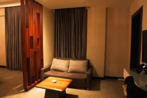 a living room with a couch and a coffee table at The Capital Heart Hotel in Baghdad