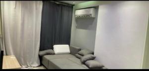 a living room with a couch with pillows at Style apartment in Cairo