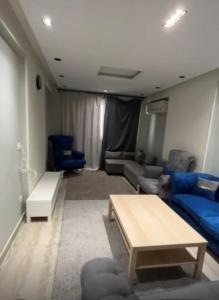 a living room with a couch and a table at Style apartment in Cairo