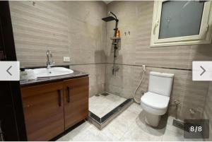 a bathroom with a toilet and a sink and a shower at Style apartment in Cairo