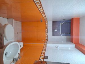 a bathroom with a tub and a toilet and a sink at Titicaca Home in Puno