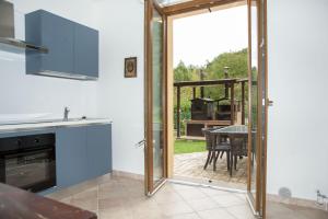 a kitchen with a sliding glass door leading to a patio at CasArmando Casa Vacanze in Foligno +14 photos