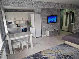 a room with a kitchen and a living room at Сдаётся однокомнатная квартира Люкс возле озера. in Balqash