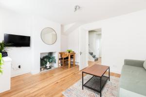 a living room with a couch and a table at Stylish 2-Bedroom Townhouse in Stratford upon Avon in Stratford-upon-Avon