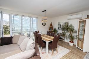 a living room with a couch and a table at Complex Saint-George spacious apartment 2 bedrooms 2 bathrooms, great seaview in Kavarna