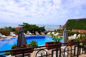 a view of a swimming pool from a hotel balcony at Complex Saint-George spacious apartment 2 bedrooms 2 bathrooms, great seaview in Kavarna