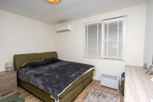 a bedroom with a bed and a window at Complex Saint-George spacious apartment 2 bedrooms 2 bathrooms, great seaview in Kavarna +25 photos