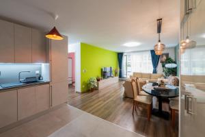 a kitchen and living room with a table and a couch at Central Premium Condo in Budapest