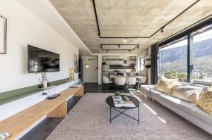 a living room with a couch and a table at Central Apartment in Cape Town in Cape Town