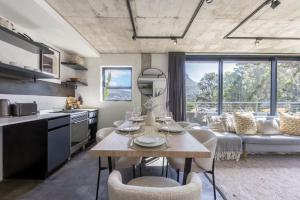 a kitchen and living room with a table and chairs at Central Apartment in Cape Town in Cape Town