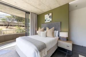 a bedroom with a large bed and a large window at Central Apartment in Cape Town in Cape Town +47 photos