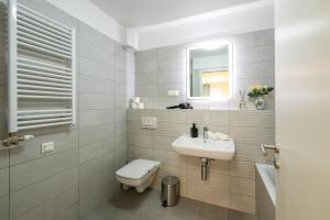 a bathroom with a sink and a toilet and a mirror at Central Premium Condo in Budapest +12 photos