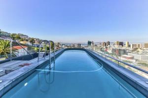 a swimming pool on the roof of a building at Central Apartment in Cape Town in Cape Town
