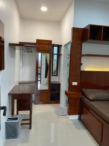 a bedroom with a bunk bed and a desk and a mirror at The Homey Coliving Lhokseumawe in Hago +23 photos