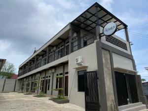 a building with a clock on the side of it at The Homey Coliving Lhokseumawe in Hago