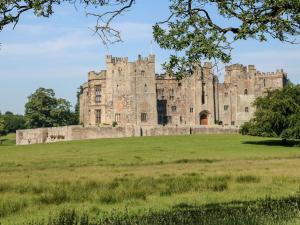 an old castle on a grassy field at Hollywood Cottage in Barnard Castle