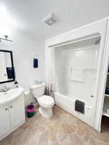 a white bathroom with a toilet and a sink at Resort Lac Ste-Marie in Lac Sainte-Marie +40 photos