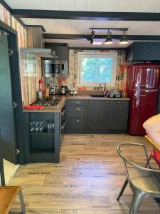 a kitchen with a red refrigerator and a stove at Pet Friendly Lodge - Sleeps6 - Long Stay Discount in Fordingbridge +14 photos