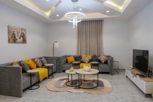 a living room with a couch and a tv at The view apartment 1 in Al Baha