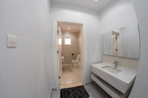 a white bathroom with a sink and a toilet at The view apartment 1 in Al Baha +39 photos