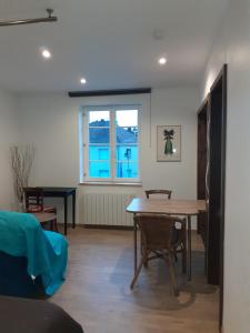 a living room with a table and a pool table at La Cigogne in Uffholtz