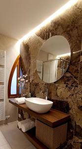 a bathroom with a sink and a mirror at Dom City Apartments in Trento +70 photos