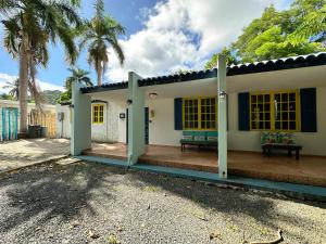 a house with a porch with a bench on it at Rainforest View with Spa 4 Bed 3 Bath Sleeps 8 in Rio Grande