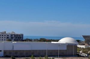 a building with a observatory in front of the ocean at Azur Apartment essaouira in Essaouira