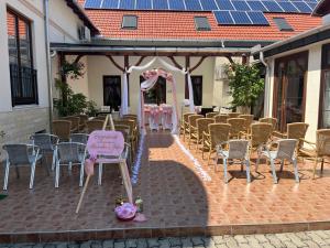 a group of chairs and a table with a sign at Meggyes Hotel in Szerencs +44 photos