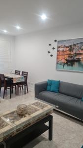 a living room with a couch and a table at Maligueira Apartment in Leiria
