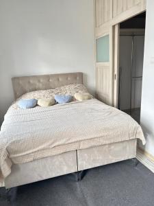 a white bed with pillows in a white bedroom at Libellula in Drawsko Pomorskie
