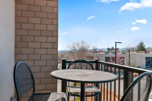 a table and chairs on a balcony with a view at 2BR Condo with Balcony, Free Tix, Walk to Downtown in Asheville