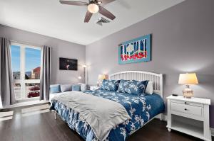 a bedroom with a bed and a ceiling fan at 2BR Condo with Balcony, Free Tix, Walk to Downtown in Asheville
