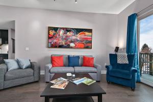 a living room with two couches and a coffee table at 2BR Condo with Balcony, Free Tix, Walk to Downtown in Asheville