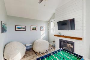 a living room with a pool table in front of a fireplace at The Turtle Nest in Lincoln City