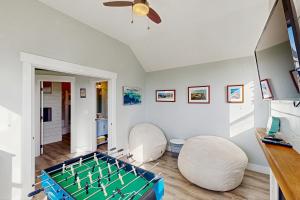 a living room with a foos ball on the floor at The Turtle Nest in Lincoln City