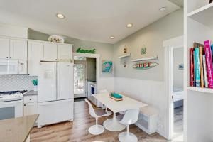 a kitchen with a table and a white refrigerator at The Turtle Nest in Lincoln City +22 photos