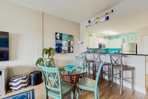 a kitchen and dining room with a table and chairs at Madeira Bay Resort 509 in St Pete Beach
