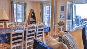 a living room with a couch and a table and chairs at Harbourside Apartment in Mevagissey