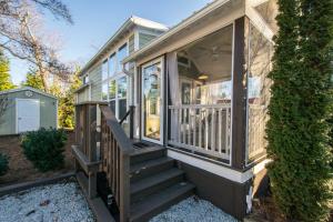 a small house with a staircase leading to a porch at Gorgeous 1BR Tiny Home with Pool and Bocce in Flat Rock +18 photos