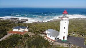 an aerial view of a lighthouse on the coast at Villa Ocean Crest B&B in Gansbaai +30 photos