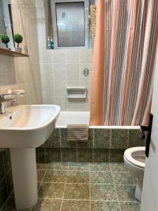 a bathroom with a sink and a toilet and a shower at Davelis House in Agios Vlasios +48 photos