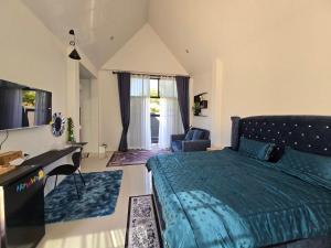 a bedroom with a bed and a desk and a window at เลอร์กบินทร์ in Kabin Buri