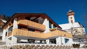 a building with a clock tower in the background at 12er Residence in Bürserberg
