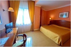 Postel nebo postele na pokoji v ubytování Hotel Conchiglia d'Oro