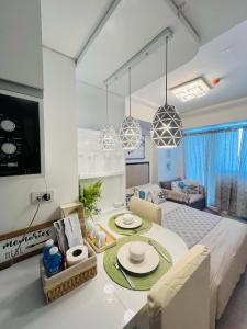 a kitchen and living room with a table and chairs at Azure North- Serenity Homes by J&J Condo rentals in Lagundi
