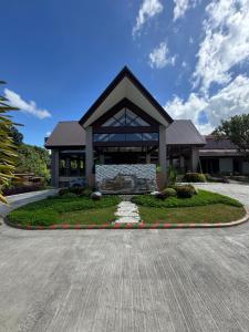 a large building with a clock in front of it at Everleigh Resort in Mataasnakahoy